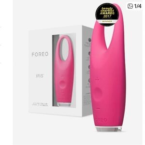 FOREO pink eye massager with USB charger and cards